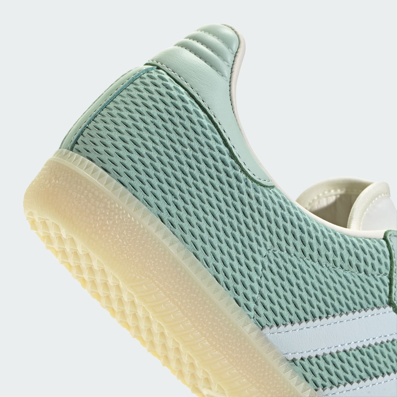 adidas Samba OG sneaker with a mesh-textured leather upper, classic T-toe overlay, and stitched heel tab, embodying vintage style with modern comfort.