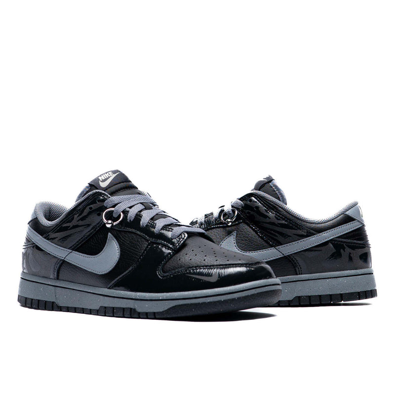 Berlin-inspired Dunk Low sneaker in black and Off-Noir, featuring glossy patent leather accents and reflective tattoo art design on the heel.