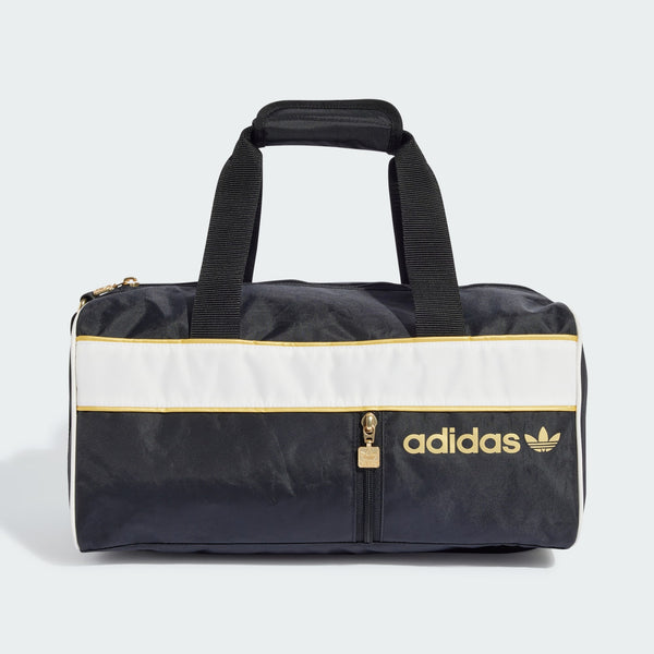 adidas duffel bag with sporty design, contrasting stripes, shiny details, front zip pocket, and adjustable shoulder strap.


