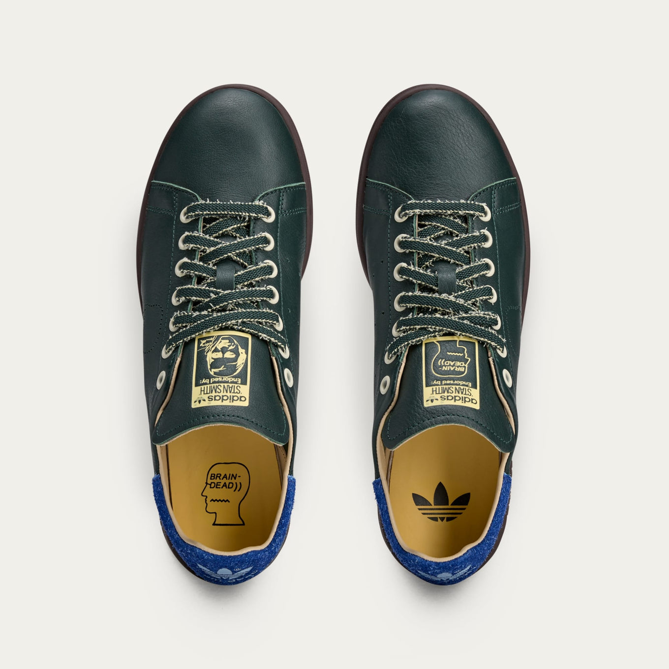 adidas Stan Smith x Brain Dead shoes featuring colorful detailing, custom laces, and unique lace chain accessory.
