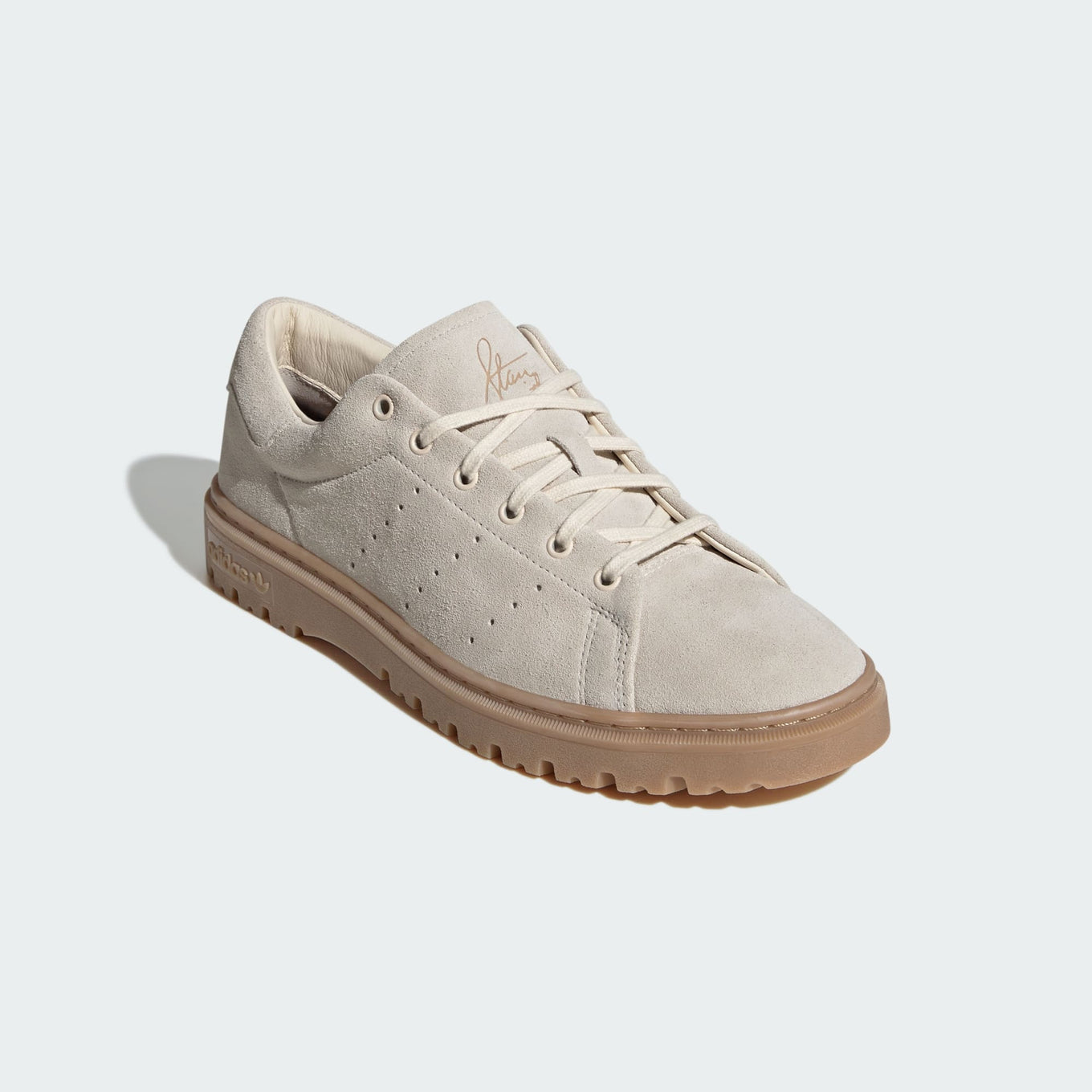 Stan Smith Freizeit sneakers with a suede upper in retro hues, a rugged rubber outsole, and classic Stan Smith branding on the tongue and heel tab.