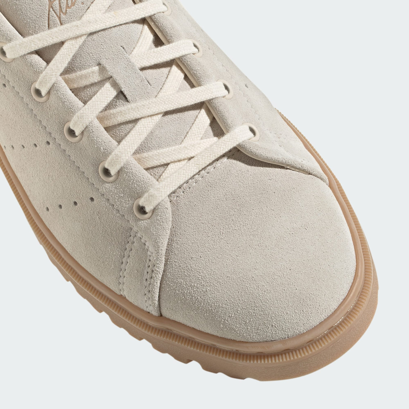 Stan Smith Freizeit sneakers with a suede upper in retro hues, a rugged rubber outsole, and classic Stan Smith branding on the tongue and heel tab.