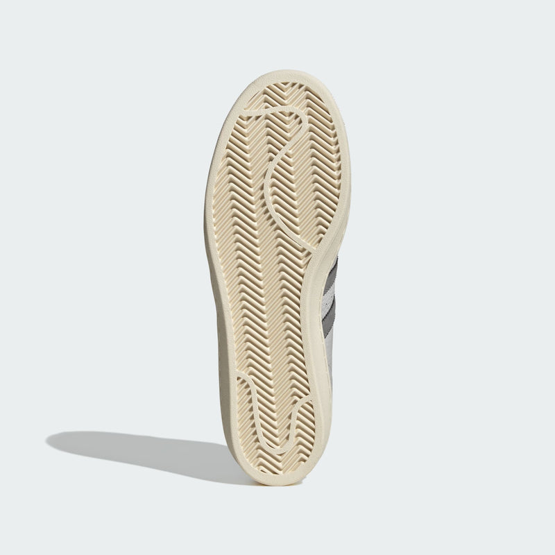 Grey adidas Superstar shoes with tonal shades and gold foil branding, inspired by the original 1969 design