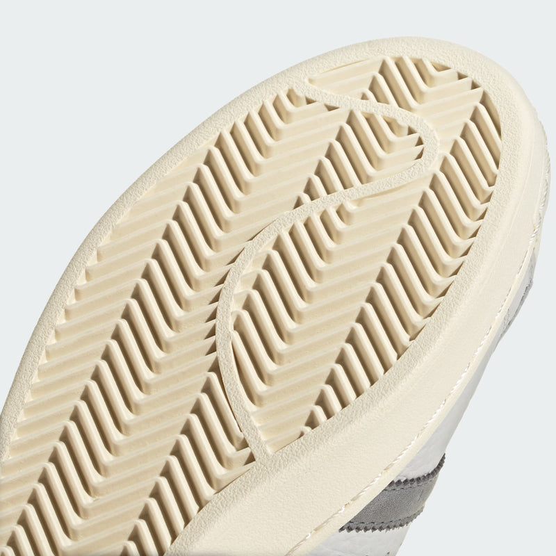 Grey adidas Superstar shoes with tonal shades and gold foil branding, inspired by the original 1969 design