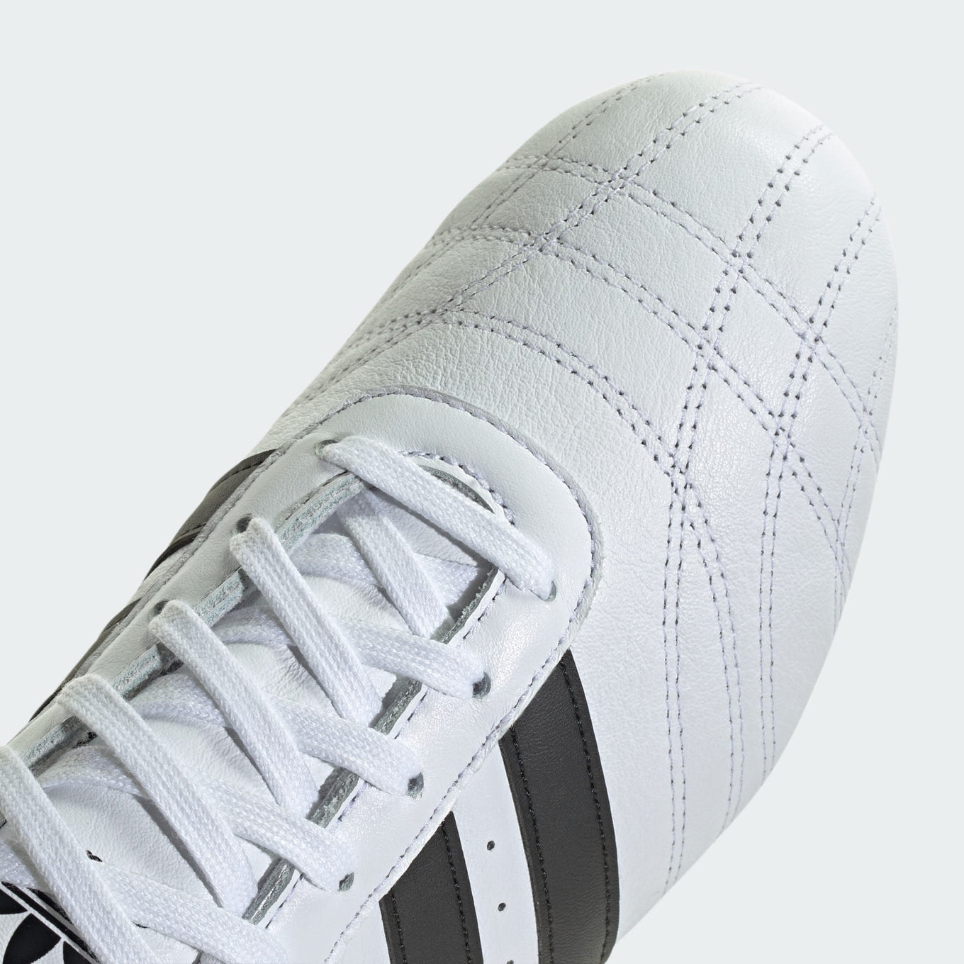 Sleek adidas trainers with minimalist design, soft leather, quilted toes, and classic 3-Stripes