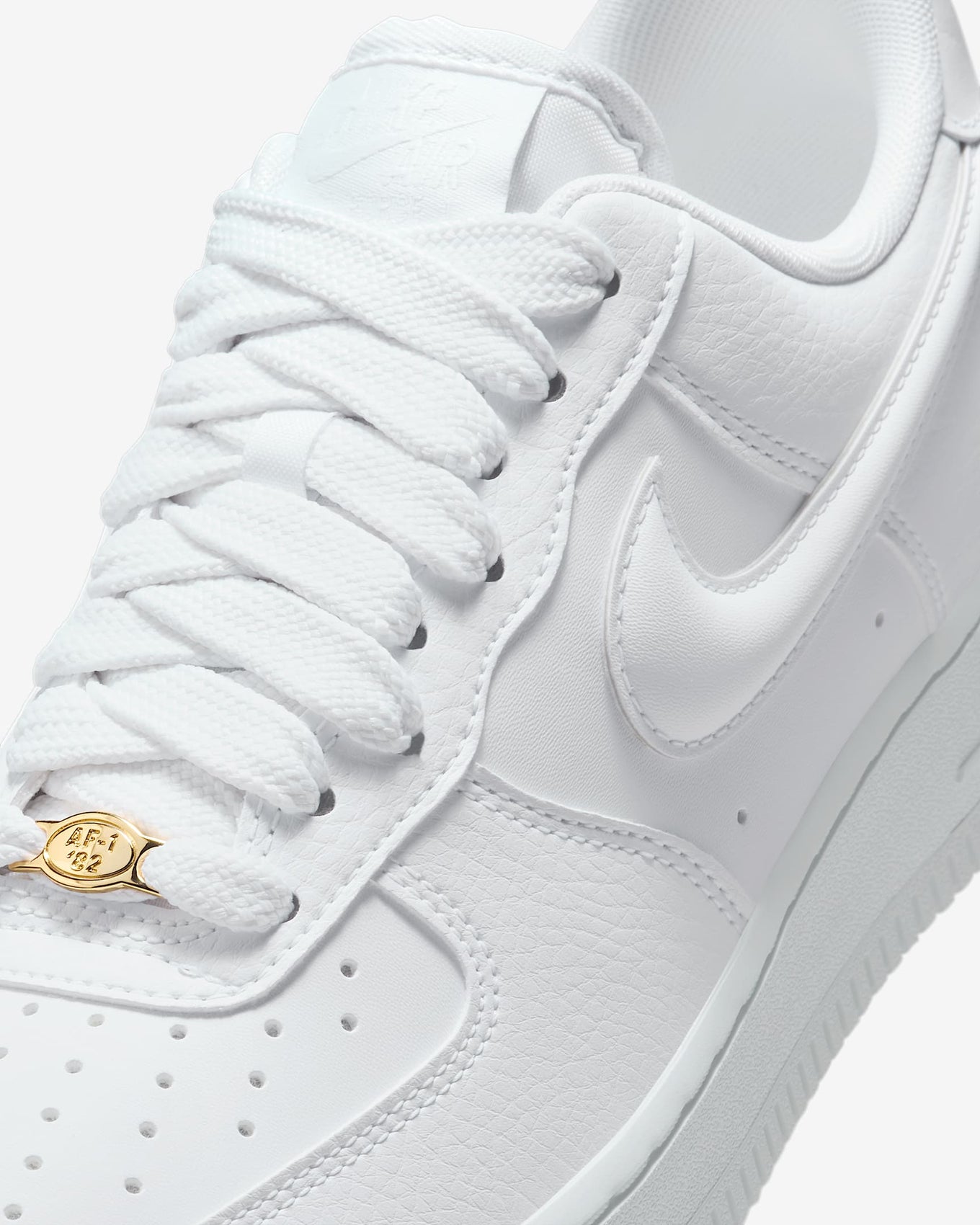 Nike Air Force 1 sneaker with classic ‘80s design, puffy Swoosh logo, and metal dubrae for a timeless and stylish look.