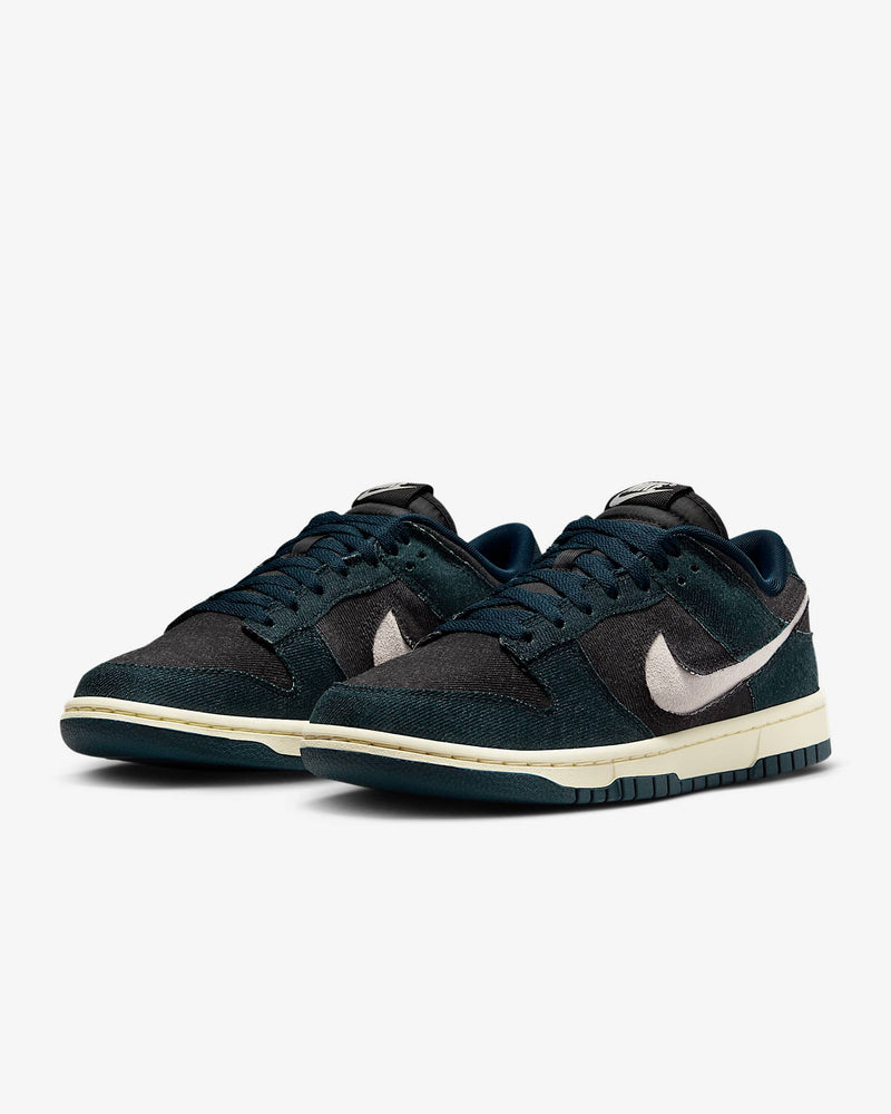 Dunk Low sneaker with iconic color blocking, corduroy layers, and plush padding for comfort and style.