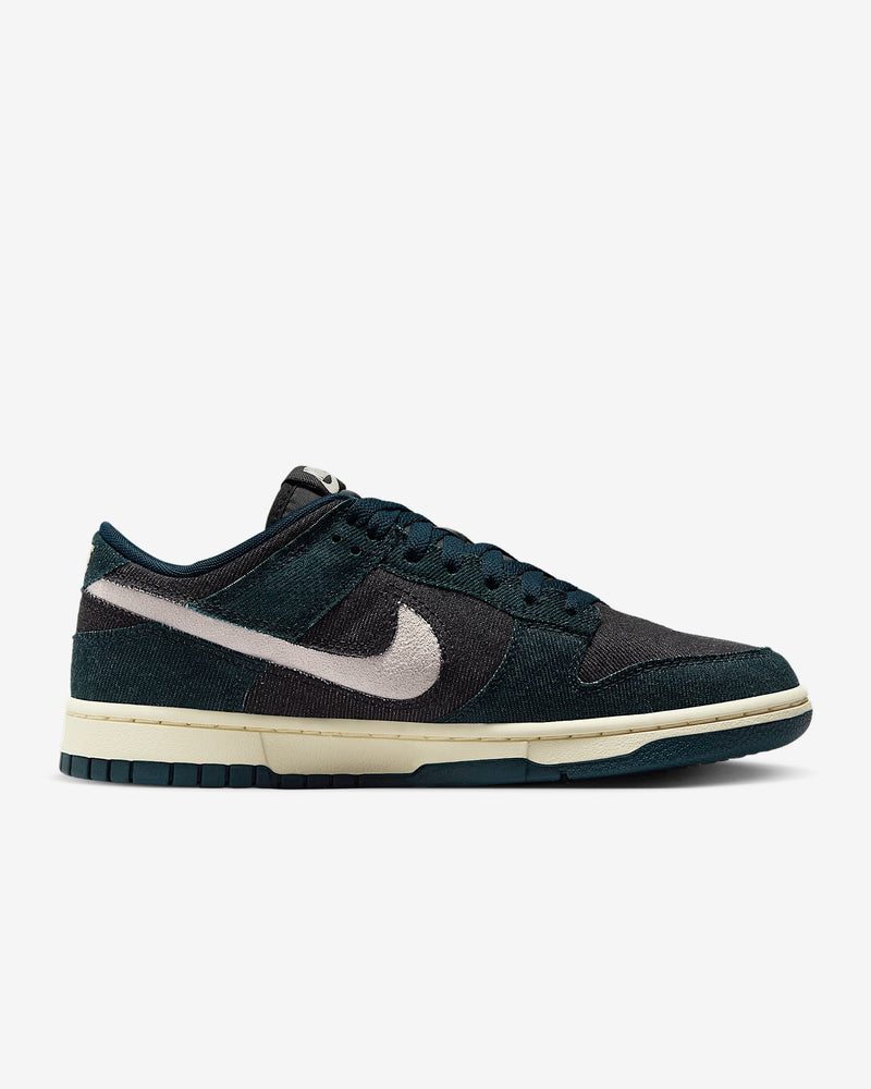 Dunk Low sneaker with iconic color blocking, corduroy layers, and plush padding for comfort and style.