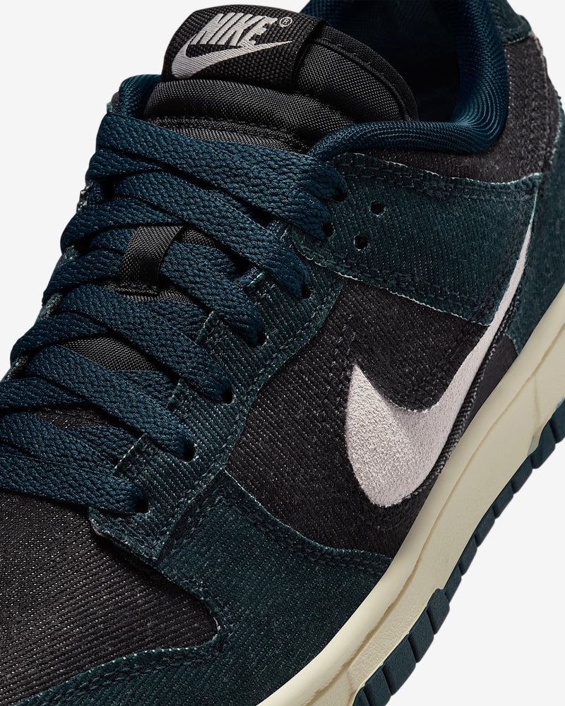 Dunk Low sneaker with iconic color blocking, corduroy layers, and plush padding for comfort and style.