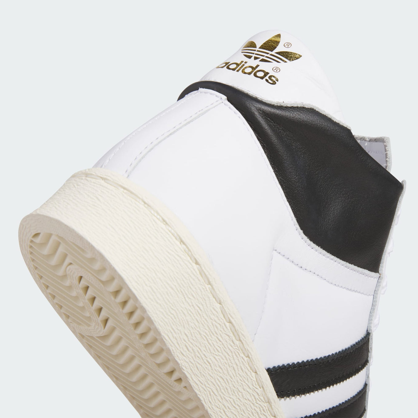 adidas Jabbar Hi sneakers with a leather upper, suede toe cap, and vintage basketball-inspired design for a timeless streetwear look.