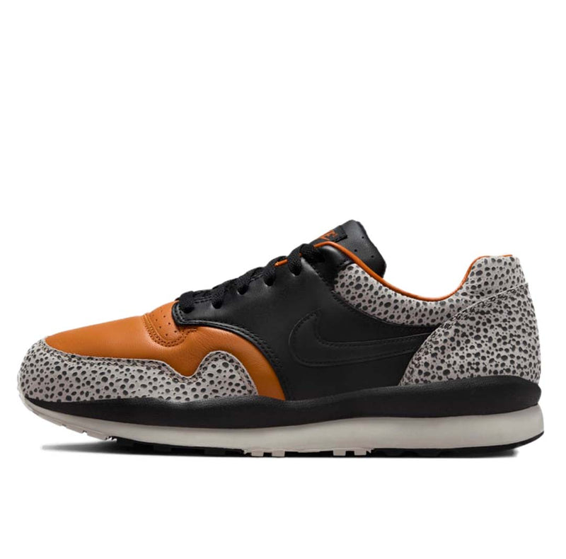 Nike Air Safari OG sneaker with safari print on toe box and heel, black and monarch leather upper, light iron ore midsole, and black rubber outsole.