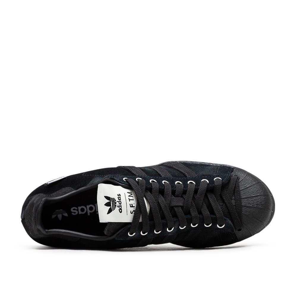 adidas Superstar 82 sneakers with a hand-buffed leather upper, tonal leather shell toe, and waxed laces, inspired by work boots.
