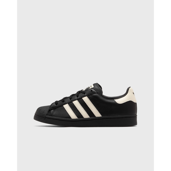 AVAVAV x adidas Originals Superstar sneaker featuring oversized, finger-like extensions on the shell toe with signature three stripes and co-branded details.