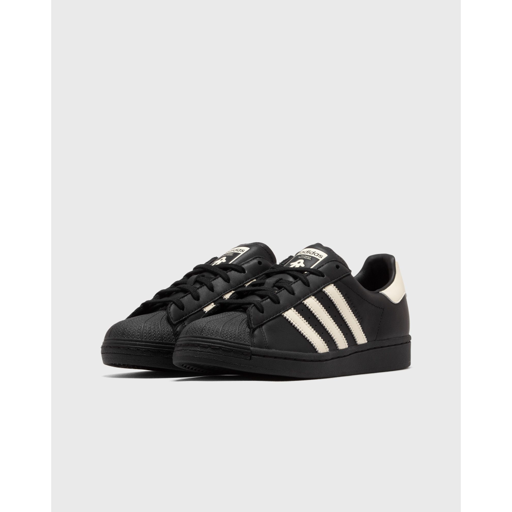 AVAVAV x adidas Originals Superstar sneaker featuring oversized, finger-like extensions on the shell toe with signature three stripes and co-branded details.