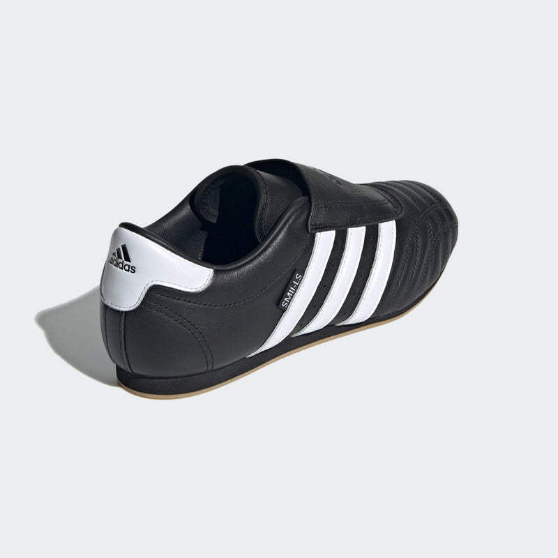 Adidas Taekwondo shoes in soft leather with slip-on design, featuring bold 3-Stripes, unique forefoot stitching, and low-profile rubber outsole.


