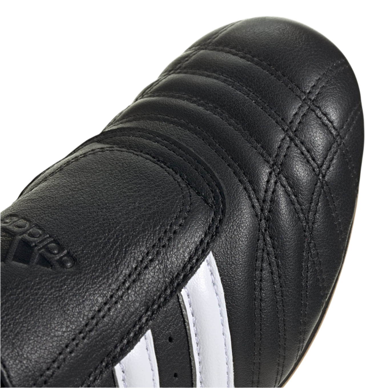 Adidas Taekwondo shoes in soft leather with slip-on design, featuring bold 3-Stripes, unique forefoot stitching, and low-profile rubber outsole.


