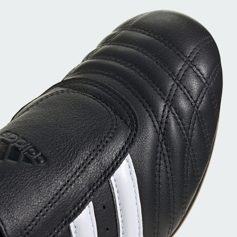 Adidas Taekwondo shoes in soft leather with slip-on design, featuring bold 3-Stripes, unique forefoot stitching, and low-profile rubber outsole.


