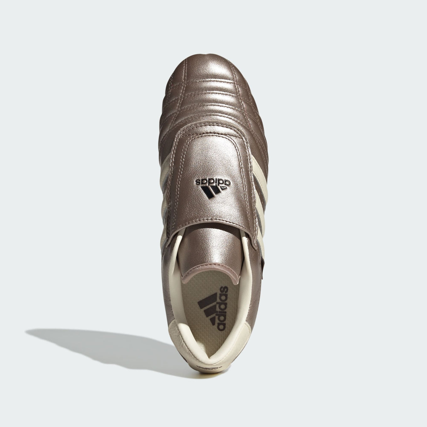 adidas Taekwondo slip-on shoes with a glossy quilted leather upper, ultra-low-profile sole, and signature 3-Stripes for a modern yet retro look.