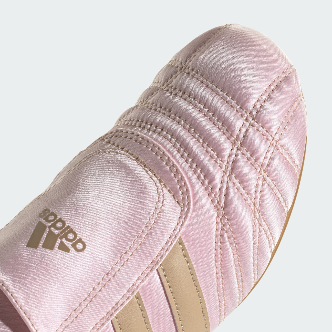 adidas slip-on shoes with smooth upper, curved stitching, and low-profile design inspired by 2000s Taekwondo trainers