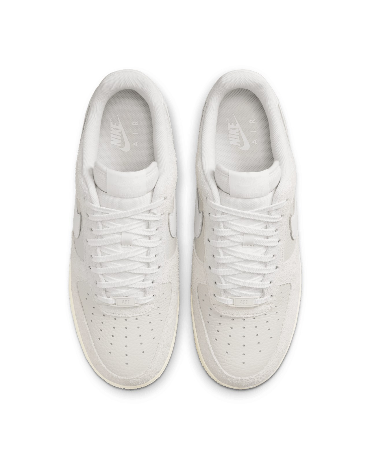 Nike Air Force 1 sneaker in Phantom and Light Bone with tumbled leather, shaggy suede details, and Coconut Milk accents for a neutral, stylish look.