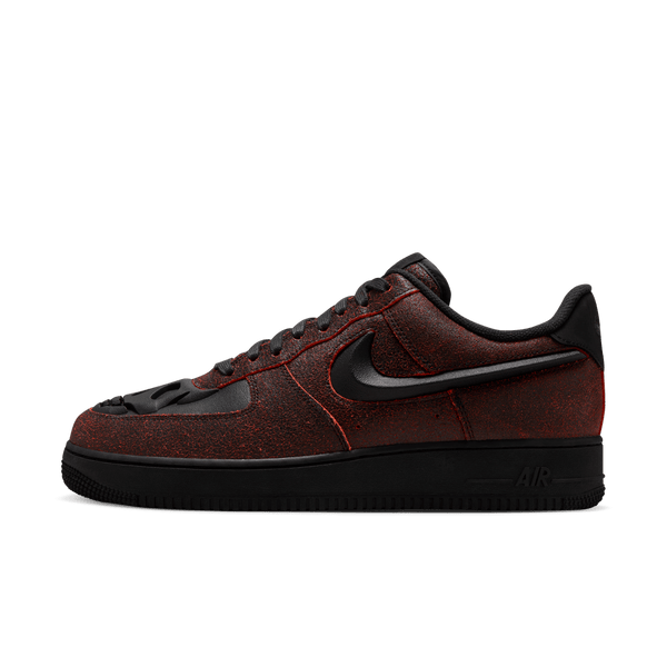 Spooky AF-1 sneakers with crackled leather finish and skull etching on toe box.