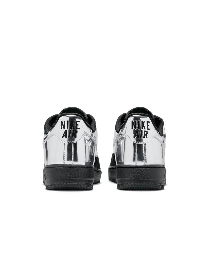 Nike Air Force 1 shoes with black suede upper, chrome accents, reflective graffiti print, and star-shaped dubraes inspired by hip-hop culture