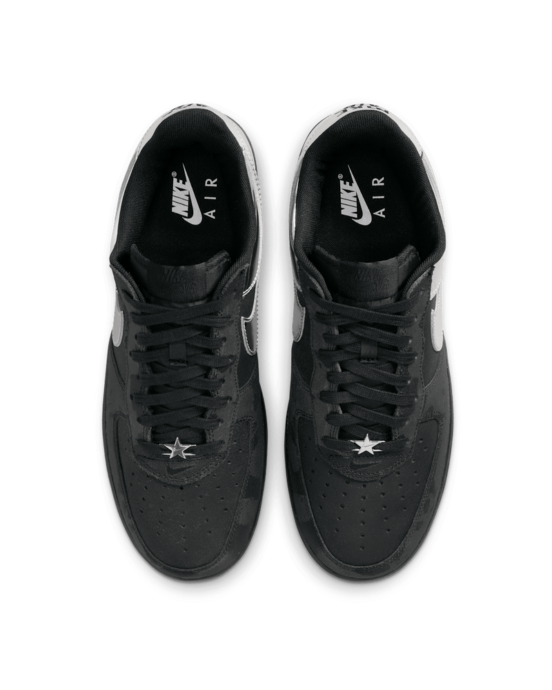 Nike Air Force 1 shoes with black suede upper, chrome accents, reflective graffiti print, and star-shaped dubraes inspired by hip-hop culture