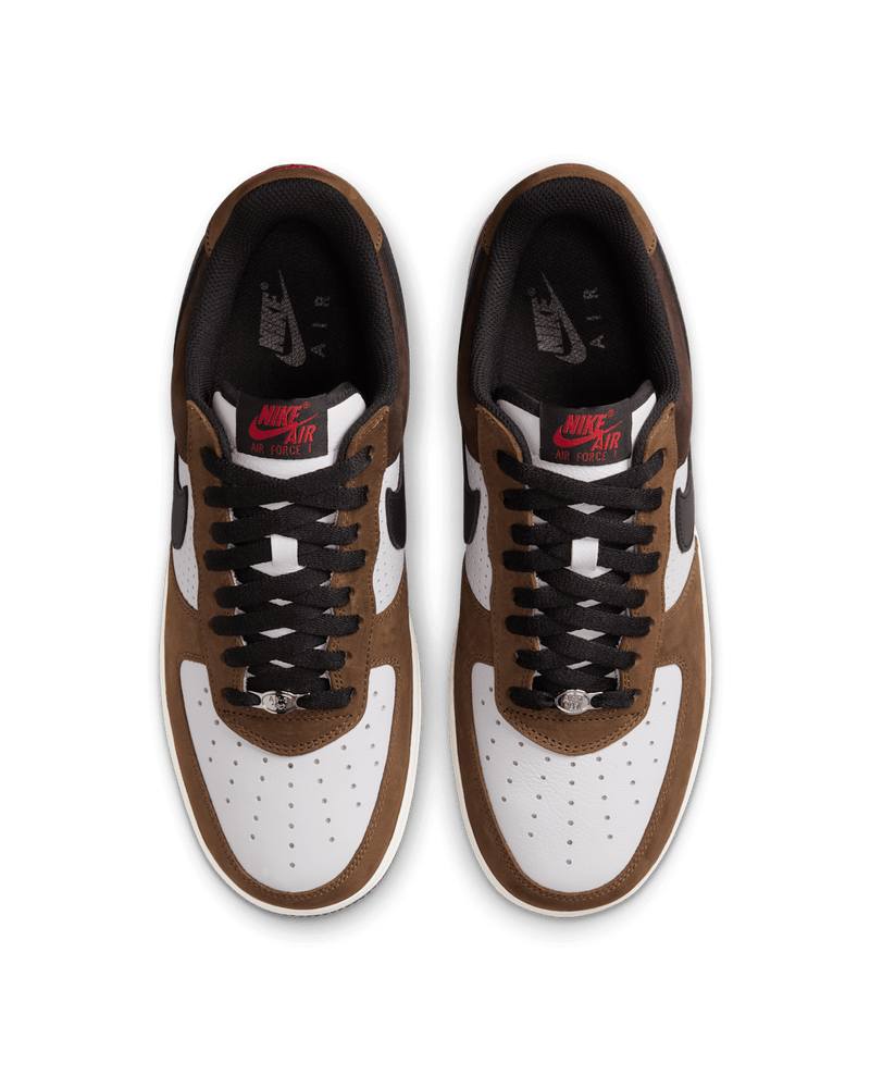 Nike Air Force 1 “Escape” with white leather upper, brown accents, and red tongue logo