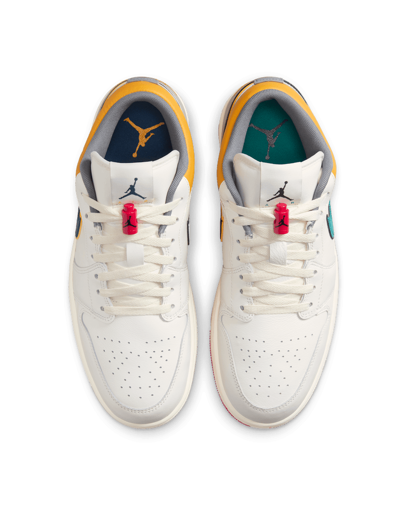 AJ1 Low Premium sneaker with Sail leather upper, Yellow Ochre and College Grey accents, dual-layered Swoosh logos, and Nike Air cushioning.