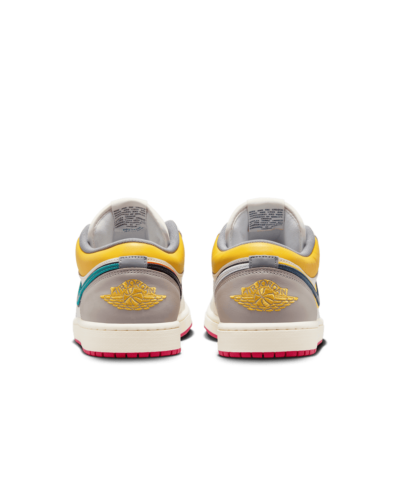 AJ1 Low Premium sneaker with Sail leather upper, Yellow Ochre and College Grey accents, dual-layered Swoosh logos, and Nike Air cushioning.