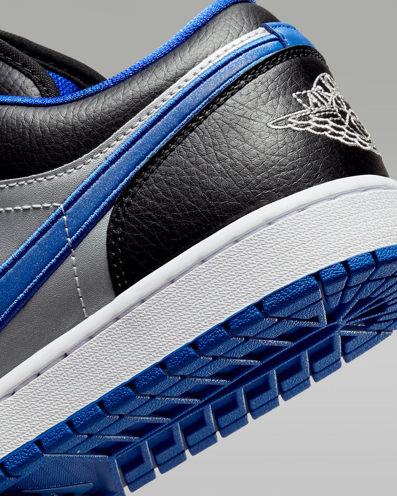 Air Jordan 1 Low sneakers with iconic 1985-inspired design, blending sleek style and timeless appeal to complement any outfit.