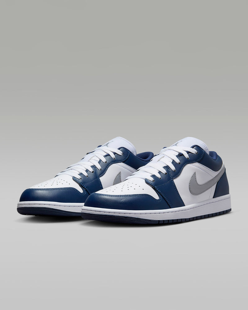 Air Jordan 1 Low sneakers with iconic 1985-inspired design, blending sleek style and timeless appeal to complement any outfit.