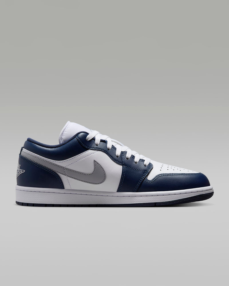 Air Jordan 1 Low sneakers with iconic 1985-inspired design, blending sleek style and timeless appeal to complement any outfit.