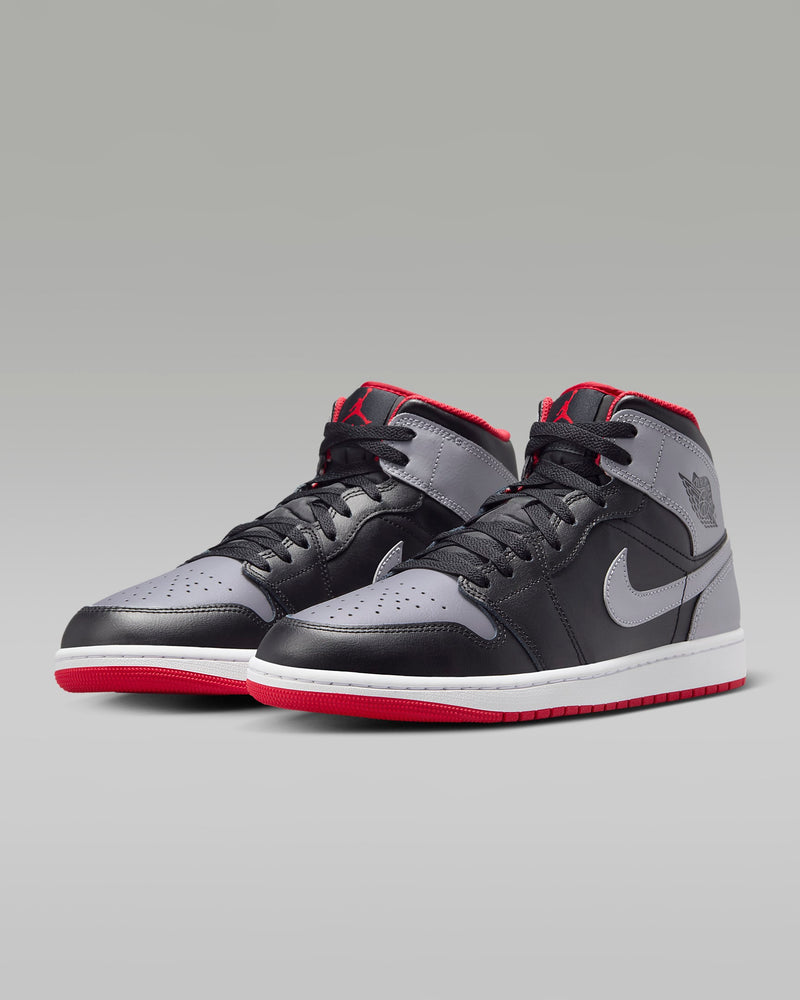 Mid-top sneaker inspired by the original Air Jordan 1, featuring iconic design elements, unique color choices, and crisp leather for a distinct and stylish identity.