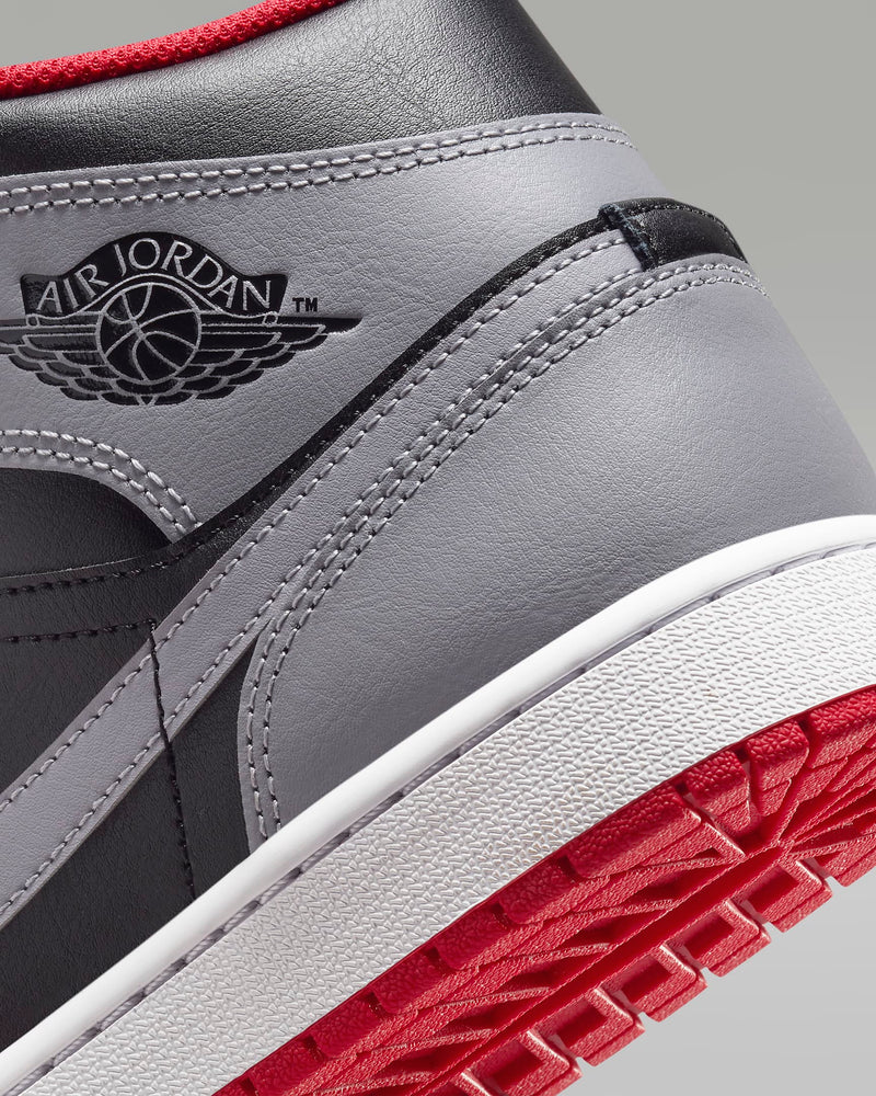 Mid-top sneaker inspired by the original Air Jordan 1, featuring iconic design elements, unique color choices, and crisp leather for a distinct and stylish identity.