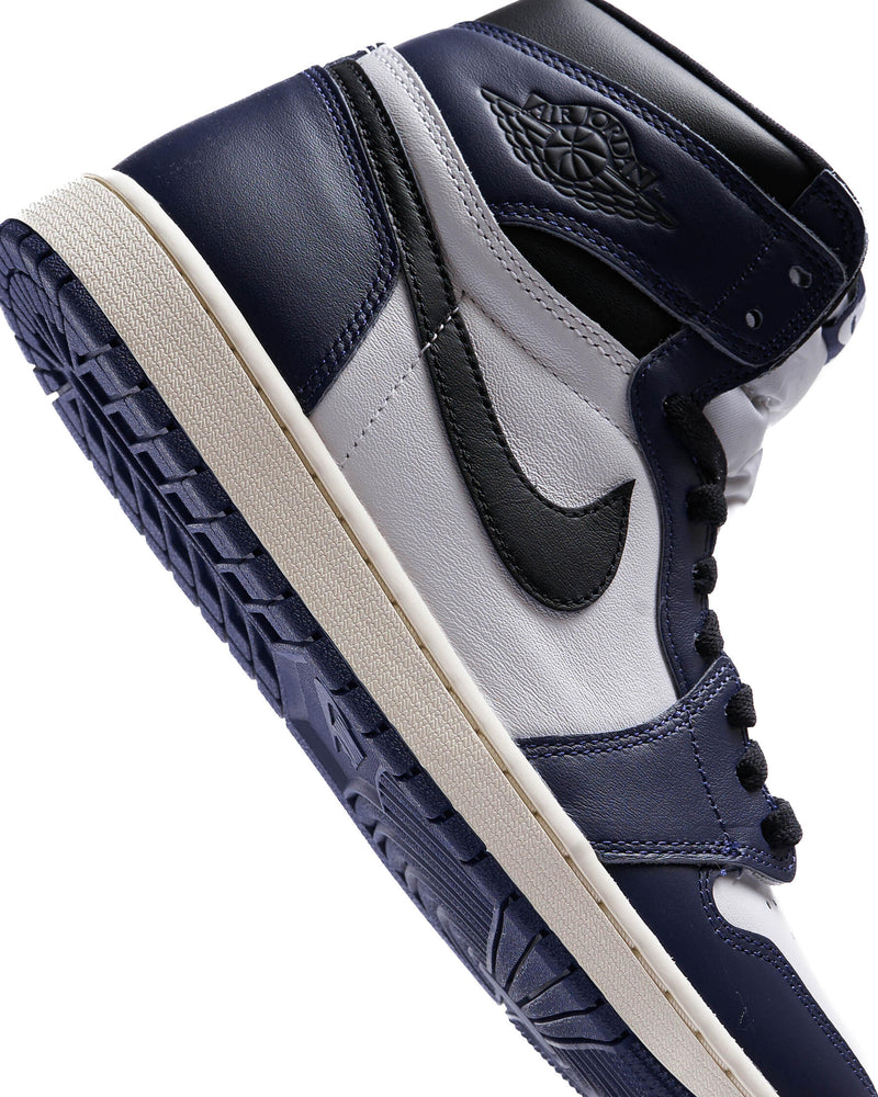 Midnight Navy leather sneaker with black accents, off-white midsole, and white tongue and panels.