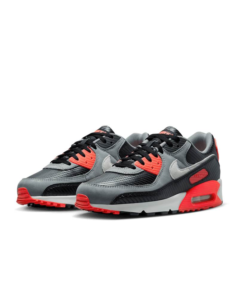 Nike Air Max 90 shoes with Cool Grey leather upper, Bright Crimson accents, black mudguard, and visible Max Air unit