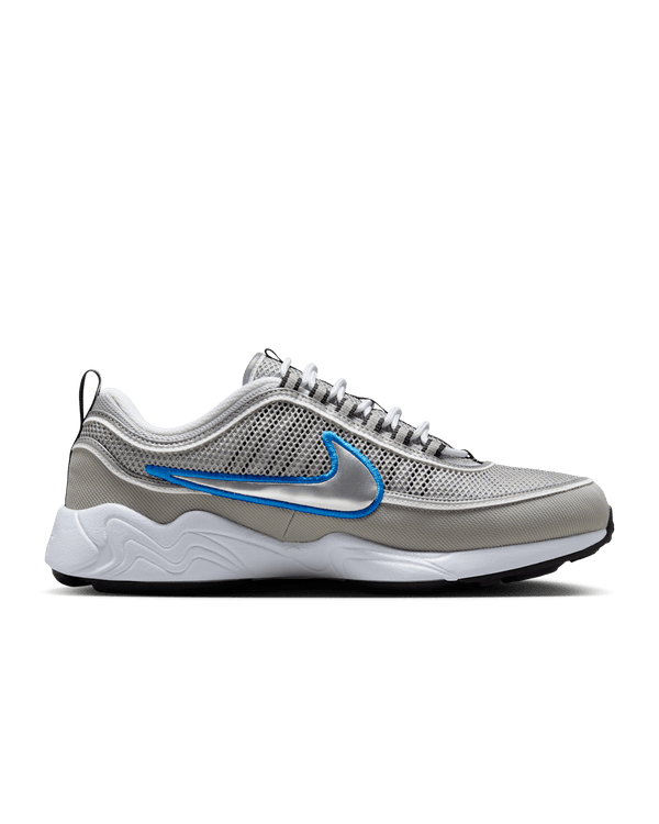 Air Zoom Spiridon retro sneaker with reflective design piping, airy mesh upper, full-length Air Zoom cushioning, and Metallic Silver and Signal Blue colorway.