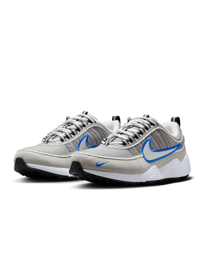Air Zoom Spiridon retro sneaker with reflective design piping, airy mesh upper, full-length Air Zoom cushioning, and Metallic Silver and Signal Blue colorway.