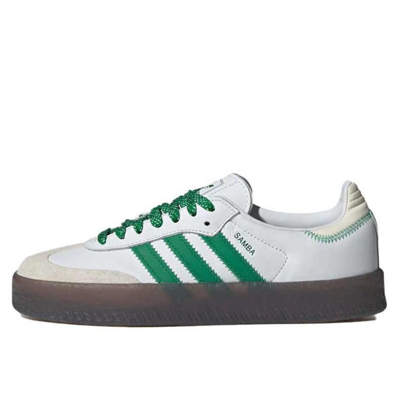 Adidas Sambae shoes with premium leather and synthetic upper, exaggerated midsole, and gum rubber outsole, featuring tongue detail in various languages.
