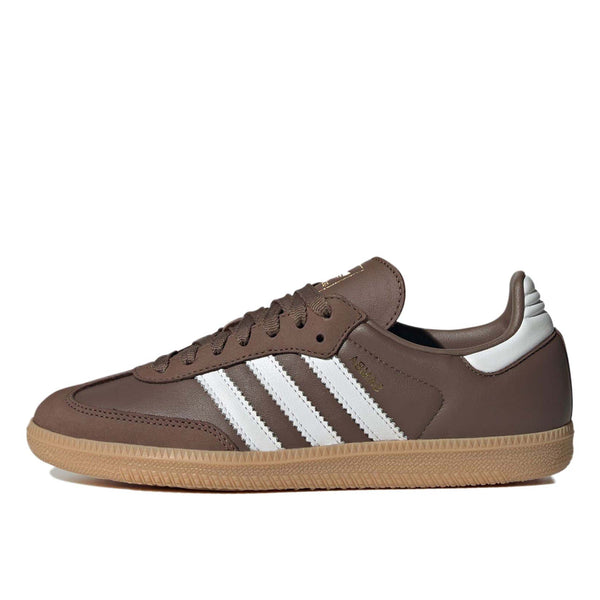 Samba OG shoes with smooth leather upper, gum rubber outsole, metallic-gold accents, and serrated 3-Stripes.