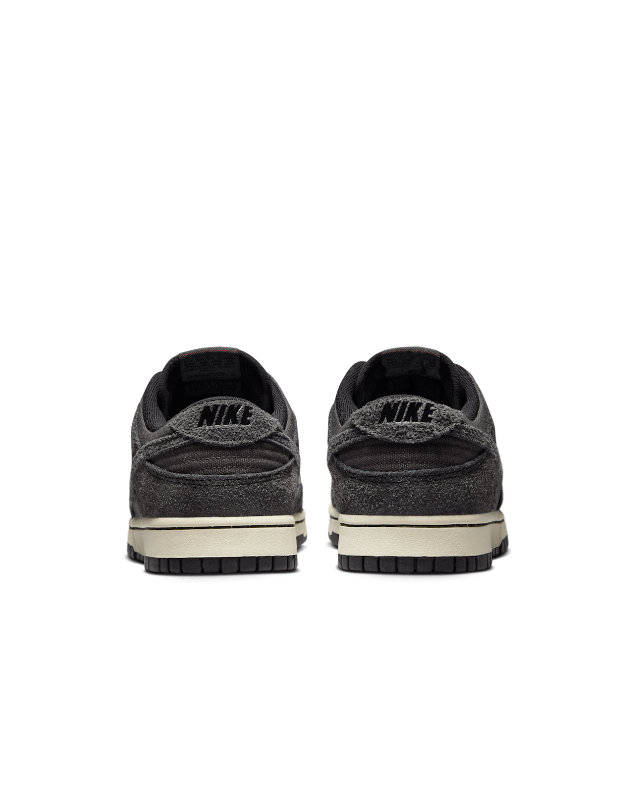 Premium Dunk Low sneaker with Medium Ash tumbled leather, black and Off-Noir shaggy suede overlays, and a timeless, statement-making design.