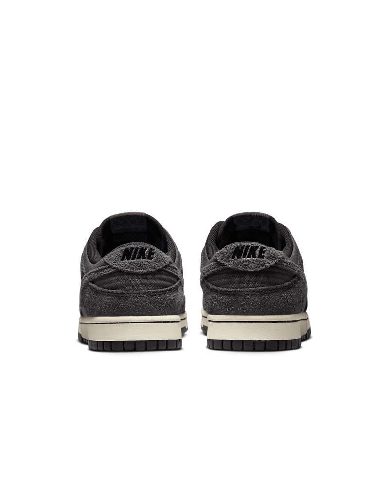 Premium Dunk Low sneaker with Medium Ash tumbled leather, black and Off-Noir shaggy suede overlays, and a timeless, statement-making design.