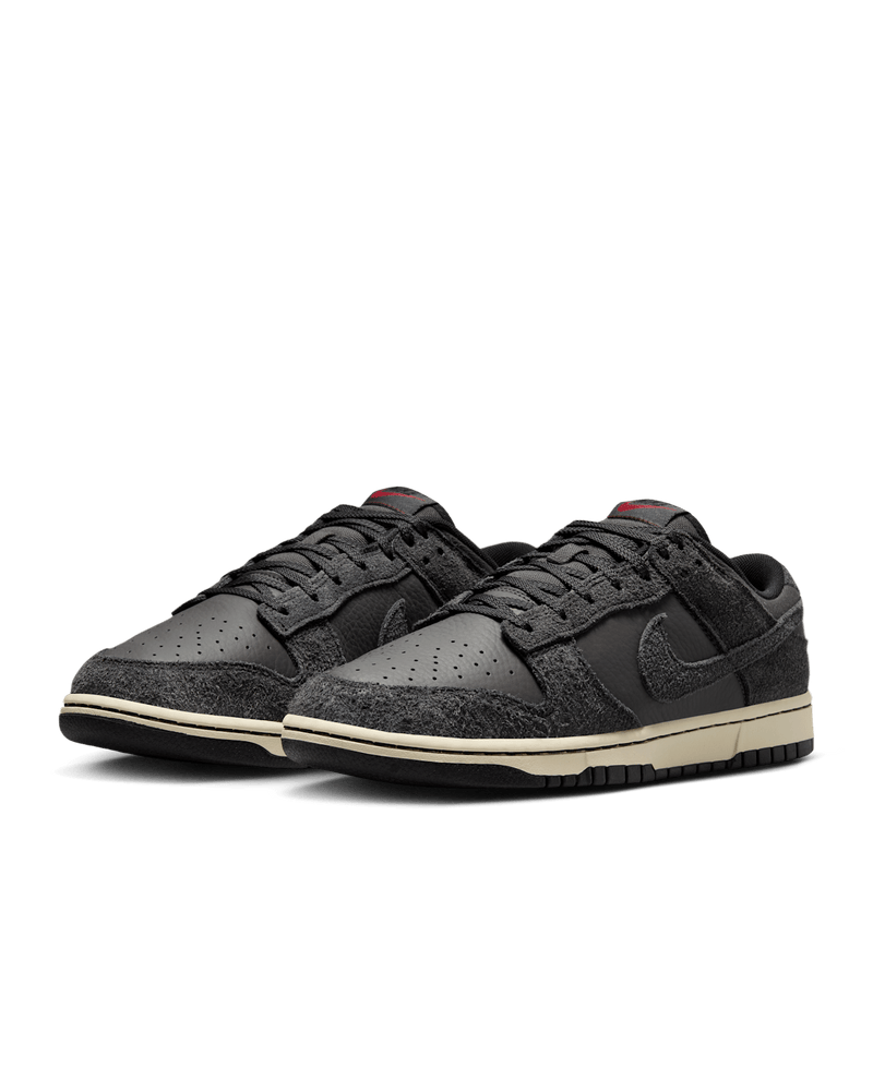 Premium Dunk Low sneaker with Medium Ash tumbled leather, black and Off-Noir shaggy suede overlays, and a timeless, statement-making design.