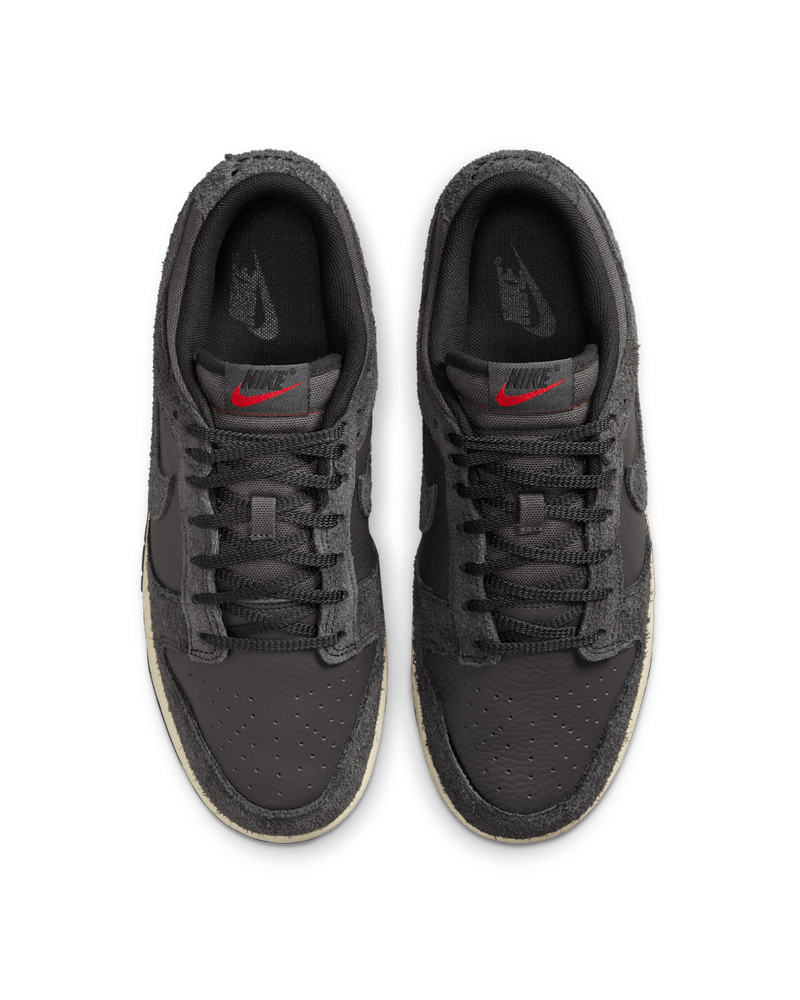 Premium Dunk Low sneaker with Medium Ash tumbled leather, black and Off-Noir shaggy suede overlays, and a timeless, statement-making design.