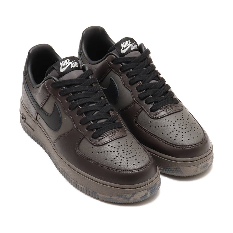 Refreshed AF-1 sneaker in dark tones with premium Black Tea and Petra Brown leather, marbled Olive Grey outsole, and sleek plated heel branding. Features Nike Air cushioning for enhanced comfort.



