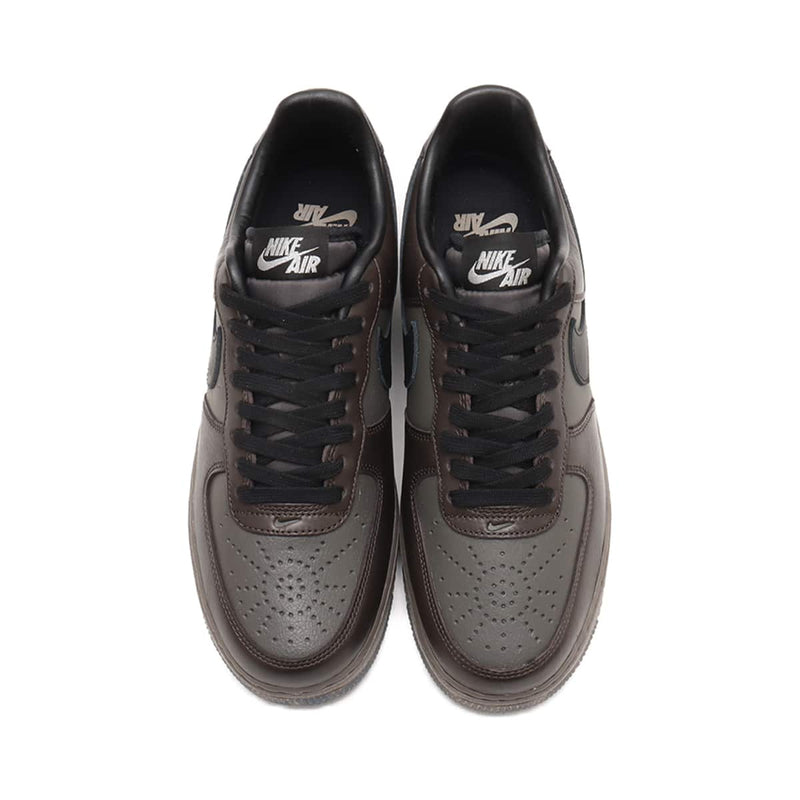 Refreshed AF-1 sneaker in dark tones with premium Black Tea and Petra Brown leather, marbled Olive Grey outsole, and sleek plated heel branding. Features Nike Air cushioning for enhanced comfort.



