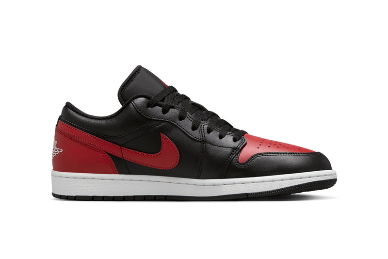 Air Jordan 1 Low "Bred" with black leather upper, red accents on the toe box, Swooshes, and heels, and black nylon tongues, combining classic design with modern comfort.