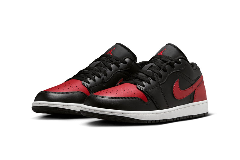 Air Jordan 1 Low "Bred" with black leather upper, red accents on the toe box, Swooshes, and heels, and black nylon tongues, combining classic design with modern comfort.