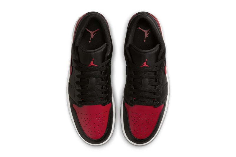 Air Jordan 1 Low "Bred" with black leather upper, red accents on the toe box, Swooshes, and heels, and black nylon tongues, combining classic design with modern comfort.